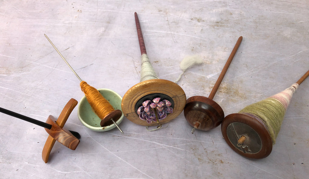 Five spindles in a row - a Turkish, a thakli and 3 top whorl spindles.