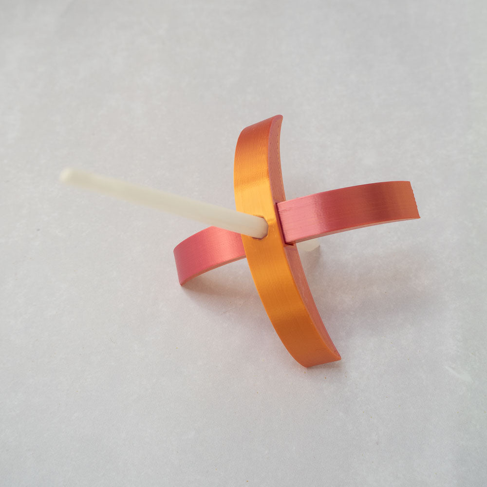 A 3d-printed Turkish drop spindle in gilded rose