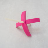 A Munchkin 3d-printed Turkish drop spindle in hot pink