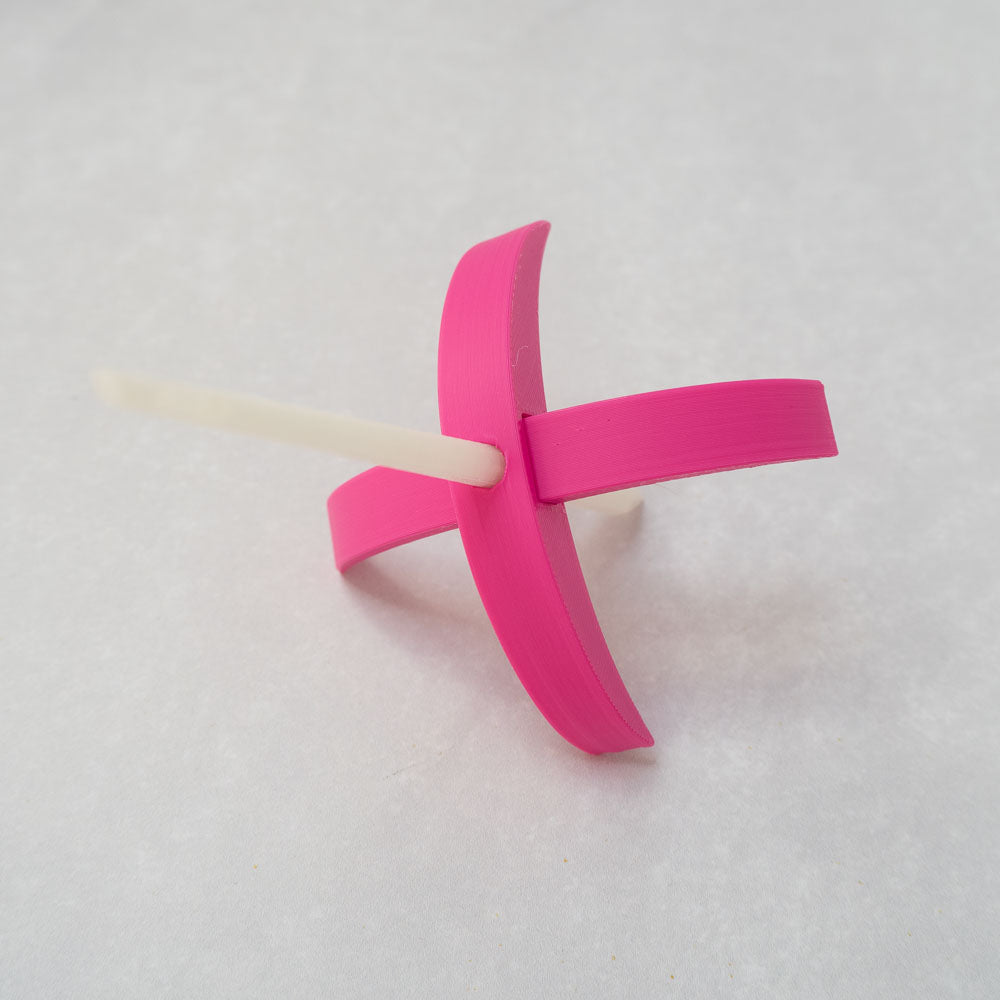 A Munchkin 3d-printed Turkish drop spindle in hot pink