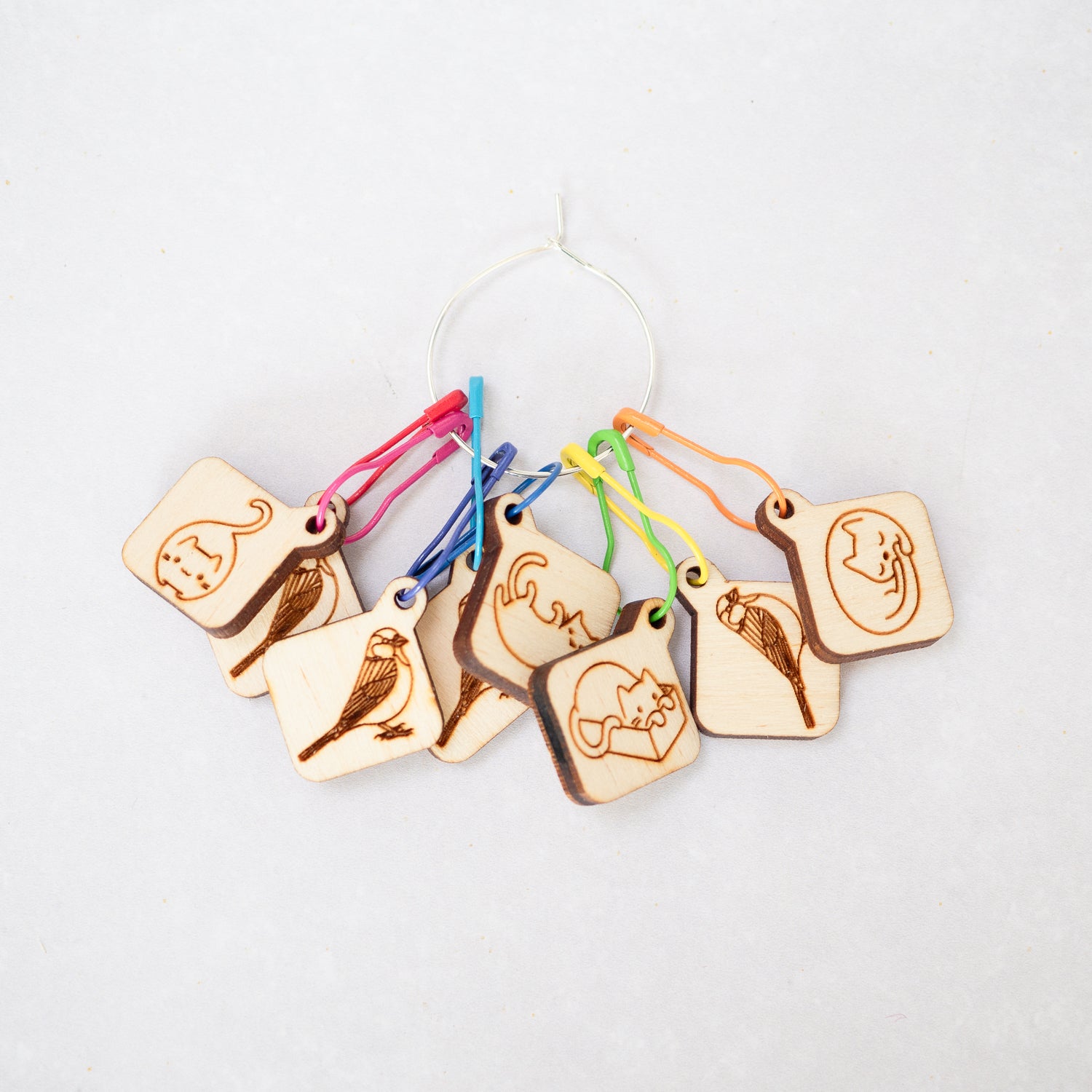 8 wooden knitting and crochet stitch markers with rainbow bulb pins