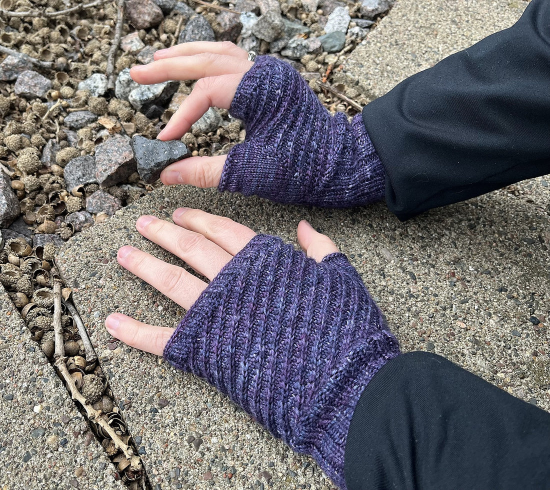 Hand-knit mittens made using Helter Skelter - an easy knitted mitt pattern - pictured in dark blue/purple yarn.