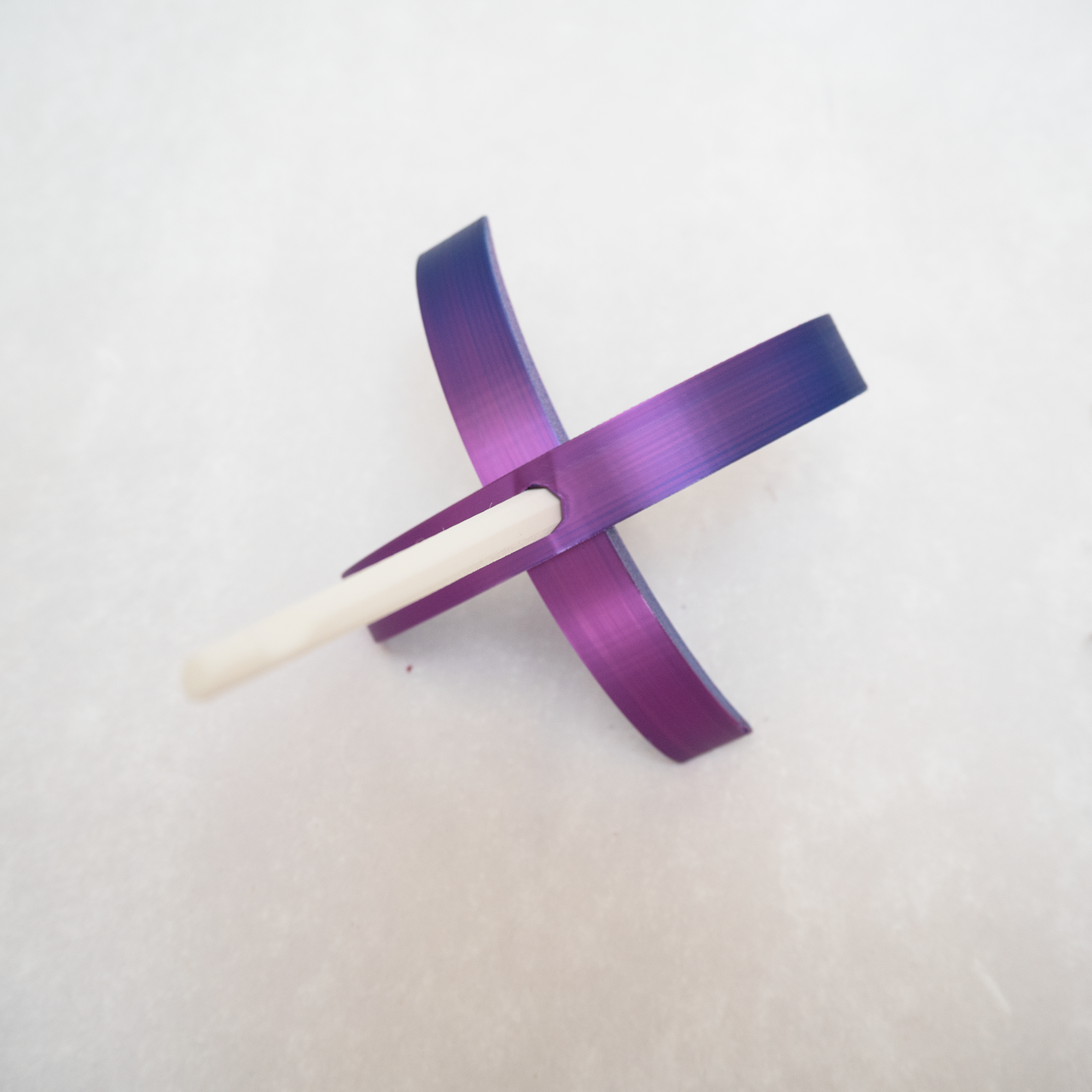 A shimmering purple Turkish drop spindle