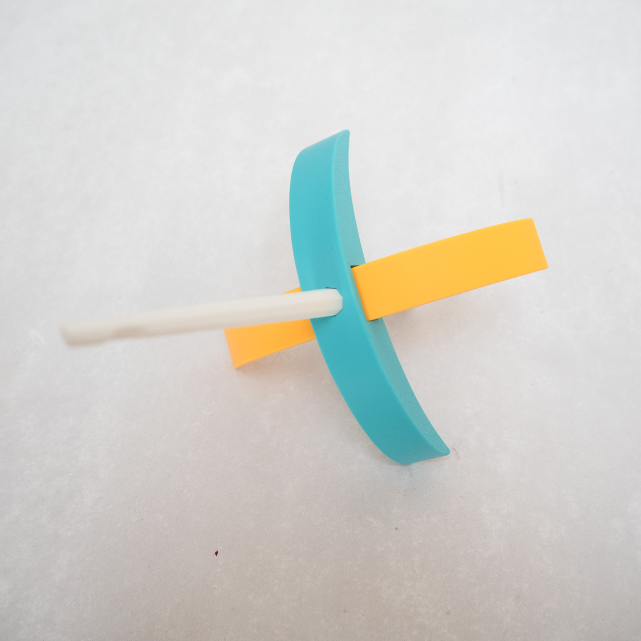 A blue and yellow turkish drop spindle