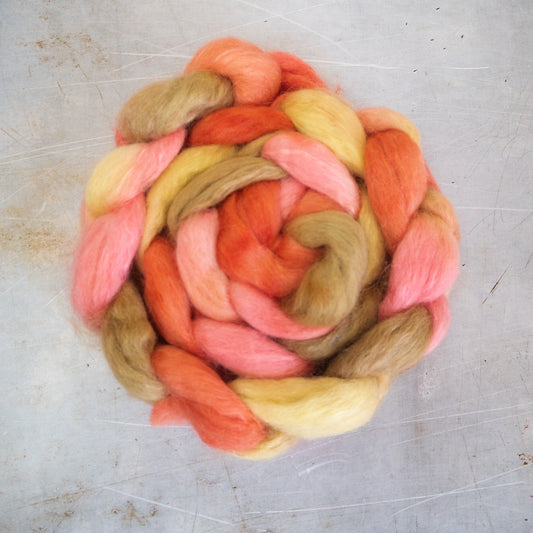 a braid of romney, polwarth and mohair combed top in soft oranges and yellows